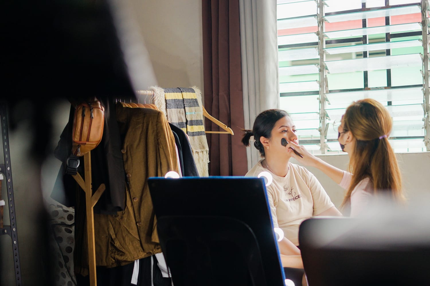 Makeup artist at work in a studio during a session